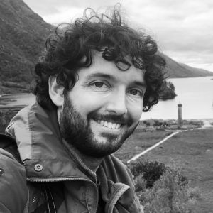 Picture of Tom Sparks, Director of Just Access. Tom is facing the camera, and a Scottish loch is visible in the background.